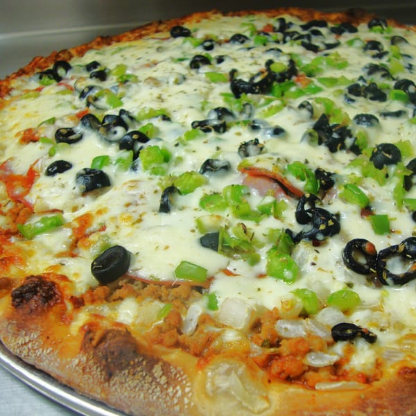 Harris Pizza's large pizza with melted cheese, black olives, green peppers, and sausage.