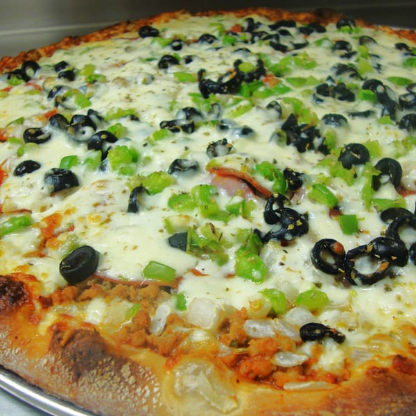 Harris Pizza with melted cheese, black olives, green peppers, and sausage.